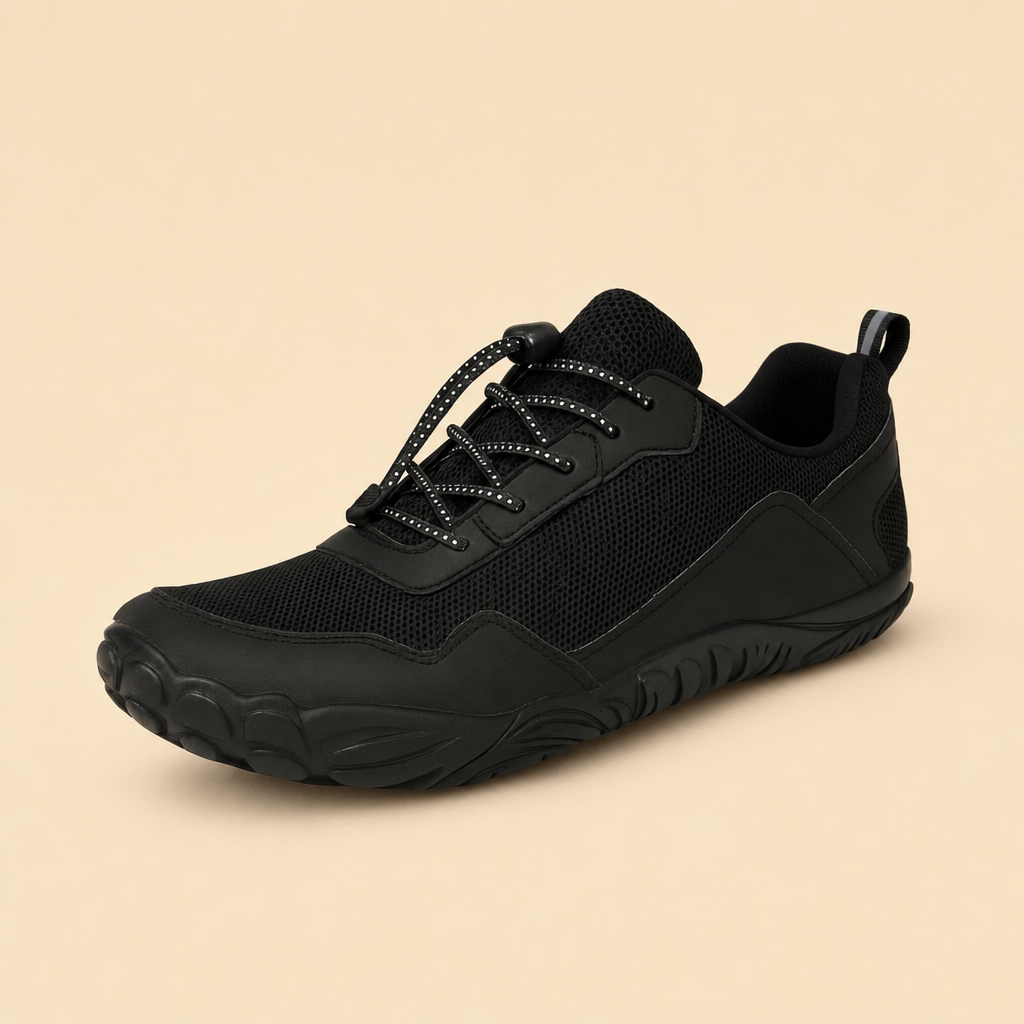 Terrix barefoot trail shoe in black on a warm beige studio backdrop
